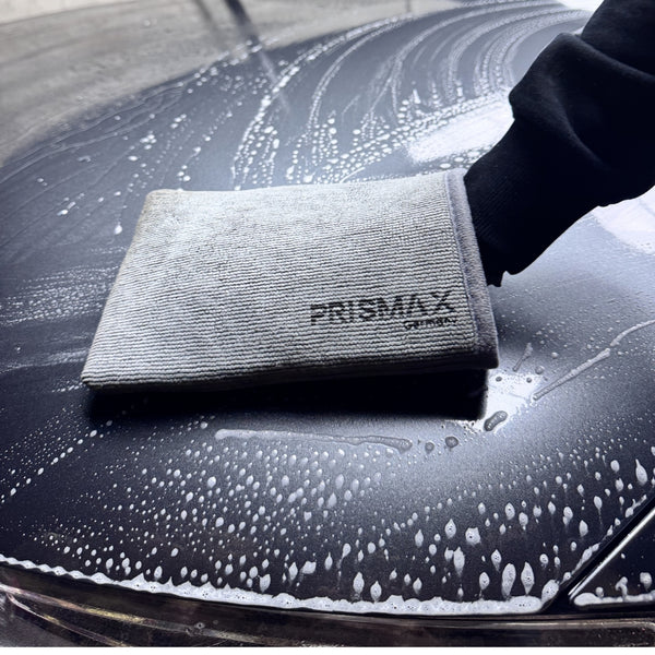 Prismax ClayMitt decontamination mitt for car detailing, shown in close-up with soft, beige clay material for removing contaminants.