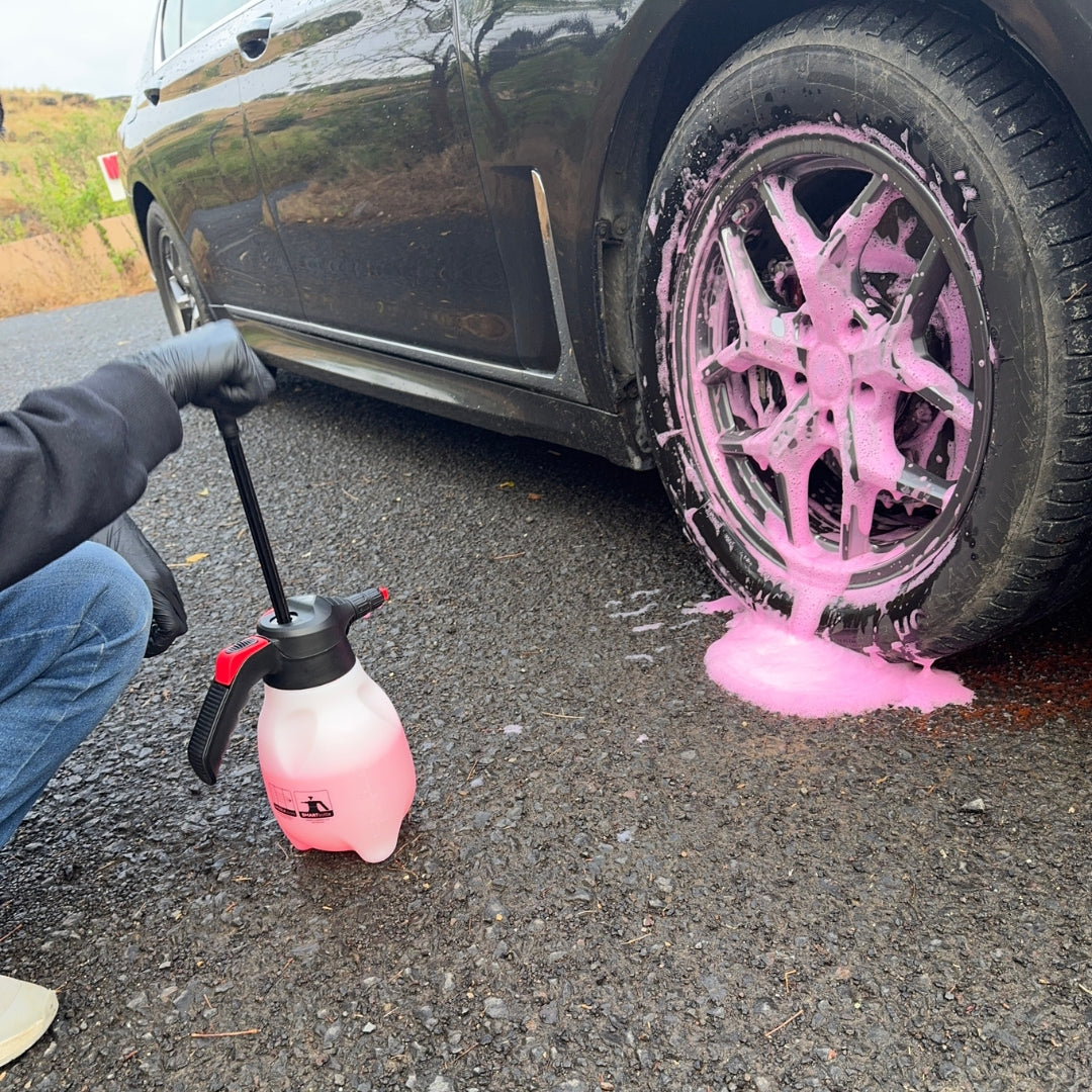 Prismax Foam Meister foam cannon for car washing, showing the white foam cannon with adjustable nozzle attached to a hose