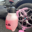 Prismax Foam Meister foam cannon attached to a garden hose, used for car washing with thick foam cleaning solution.