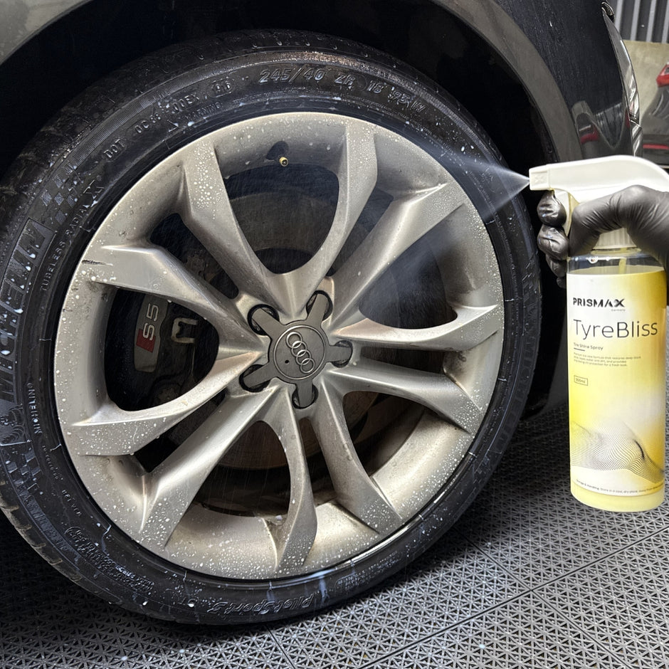Prismax TyreBliss Tire Shine Spray 500ml bottle with black spray nozzle and shiny tire surface, showcasing water-based tire shine product.