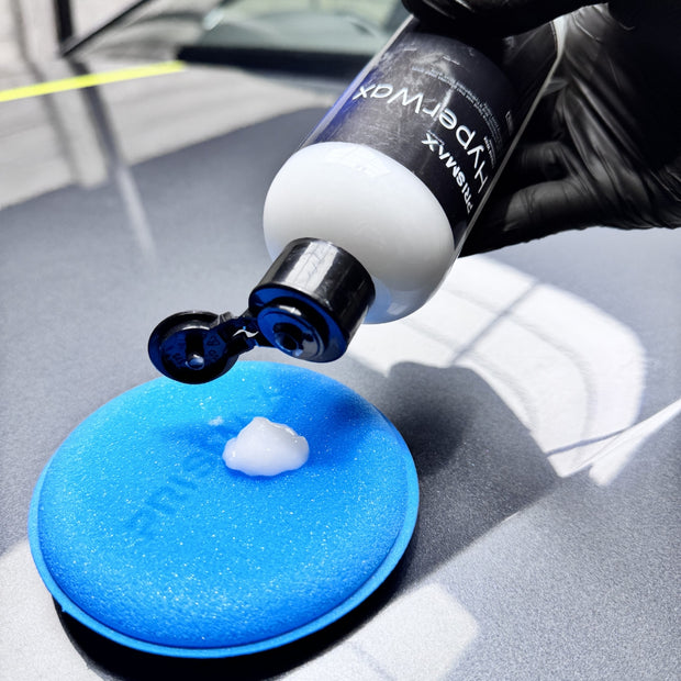 Prismax HyperWax Liquid Wax bottle for car care, featuring a sleek liquid wax product designed to protect and shine vehicle surfaces.