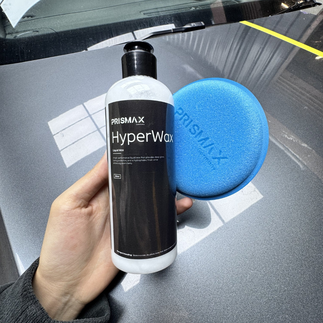 Prismax HyperWax Liquid Wax bottle for car care, showcasing the sleek container and reflective surface of the product.