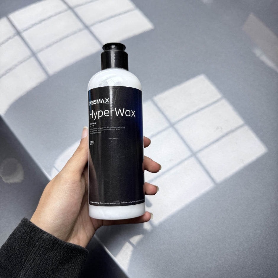 Prismax HyperWax Liquid Wax bottle with applicator pad for car paint protection and shine.