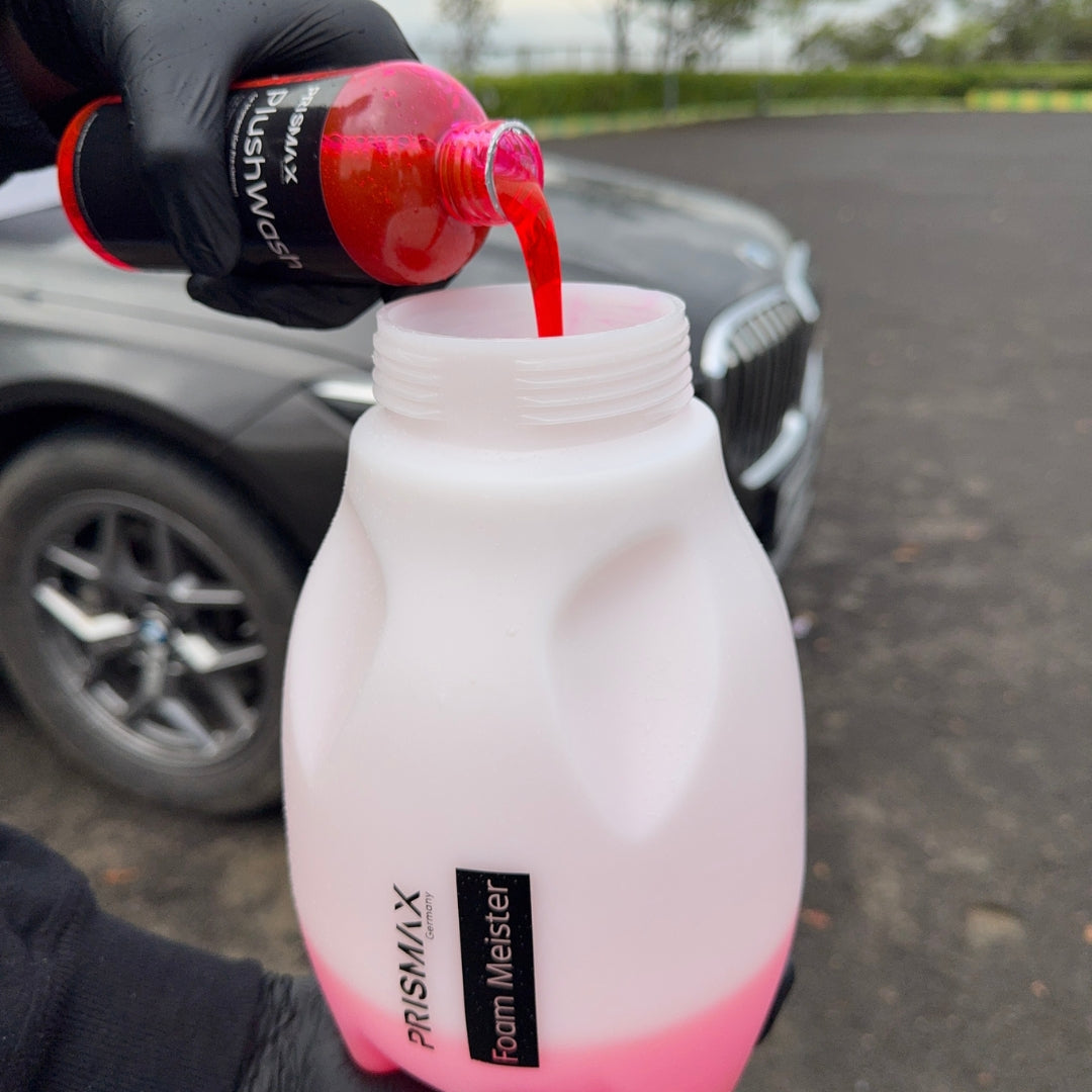 Foam Meister foam cannon by Prismax Car Care Products attached to a car hose, ready to spray thick foam for vehicle cleaning.