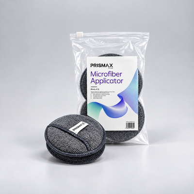 Two Prismax microfiber applicator pads for car care, soft and absorbent, ideal for applying wax, polish, or detailing products.