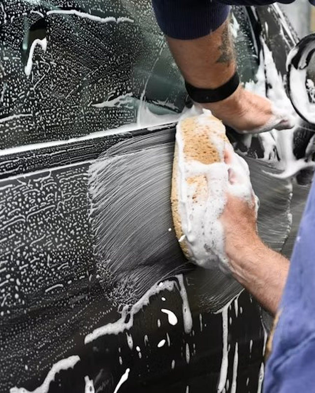 Wash mitt and foam on a car panel